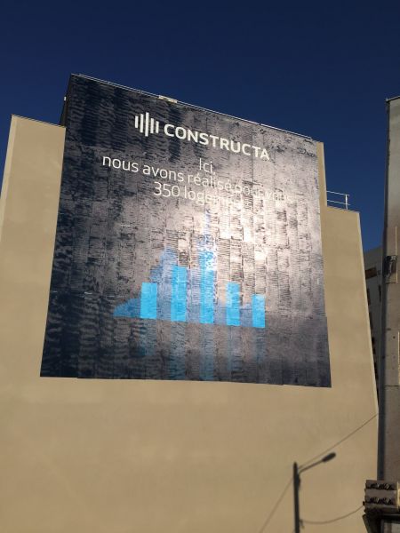 Pose d'un visuel très grand format sur un mur d'immeuble pour Constructa à Marseille
